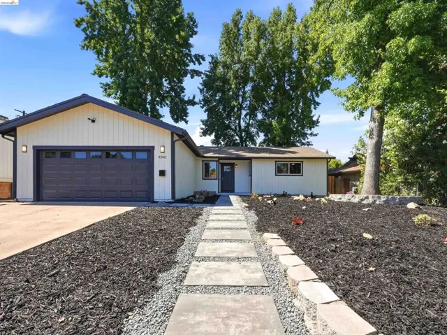 Contemporary single-story residence with a dark gray garage door