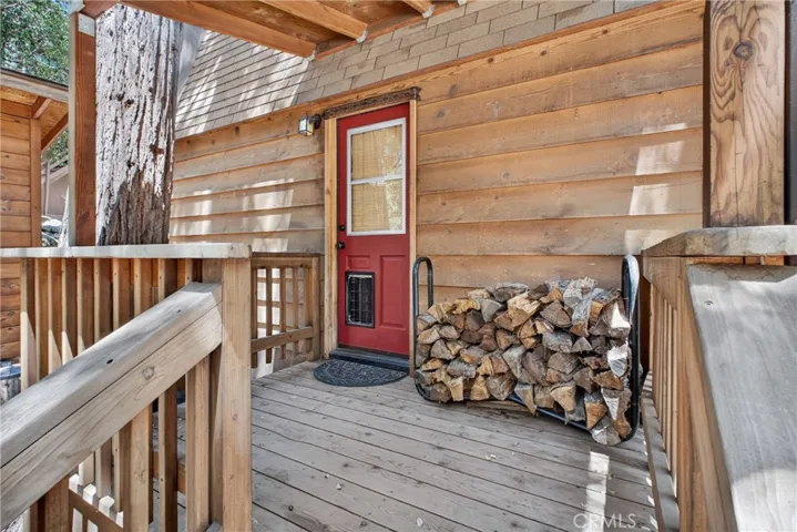 Covered Back porch keeps firewood handy.