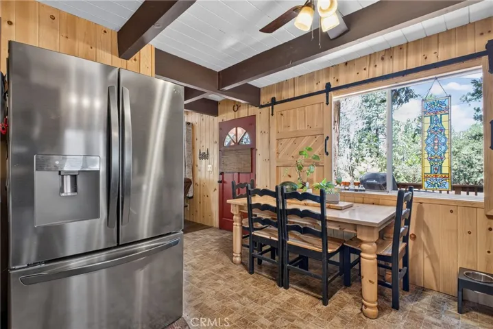 Enjoy meals with a view of the forest! Unique Barn door sliding window cover.