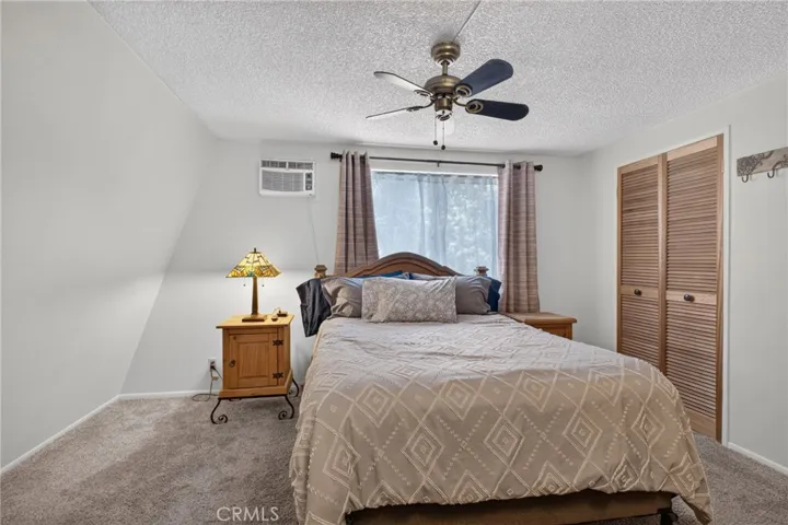 Bright and airy primary bedroom with ceiling fan