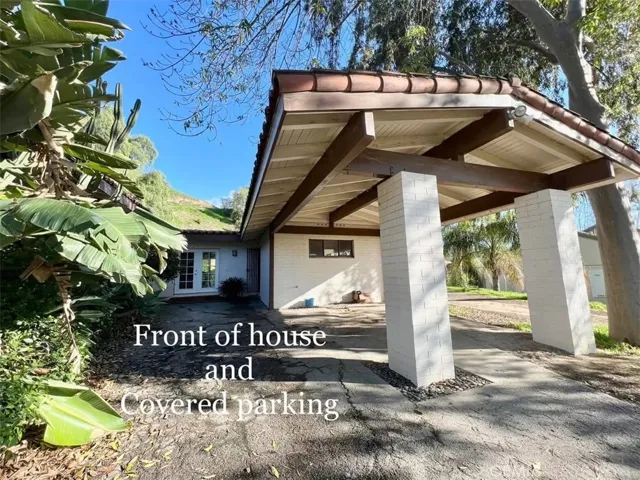Front of guest house and covered parking.