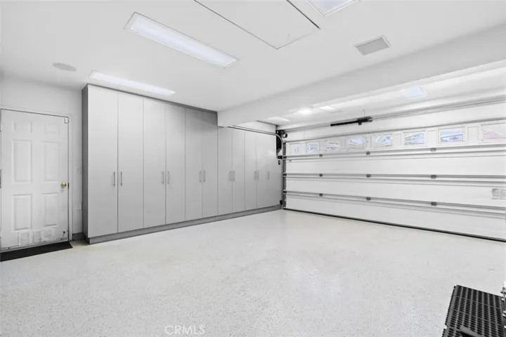 Gorgeous 3 car garage with built in cabinets throughout