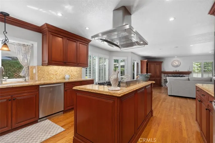 The large gourmet kitchen open to the family room and overlooks the beautiful gardens with pool and jacuzzi