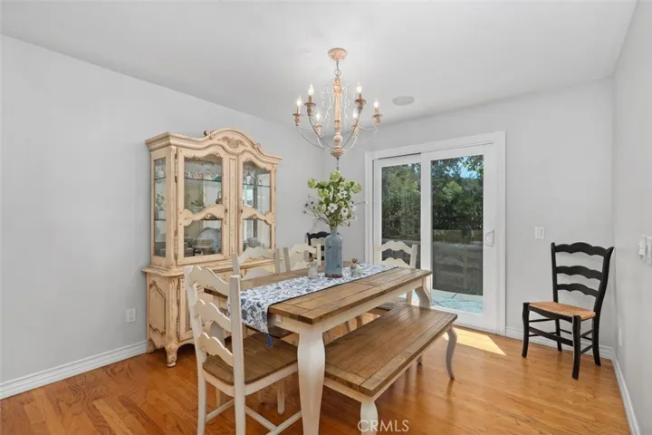 Large dining room with hardwood floors overlooking pool and spa