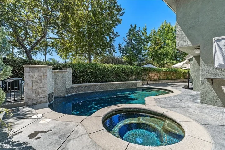 Beautiful pool and jacuzzi with a waterfall
