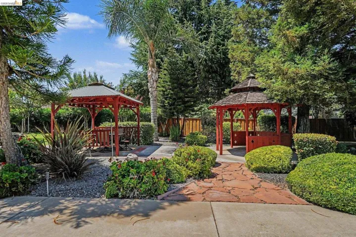 Garden area featuring two red wooden gazebos with distinct rooflines