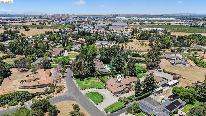 Aerial overview showcasing a residential neighborhood with varied property sizes and mature landscaping