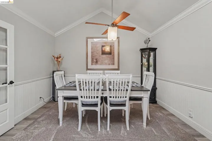 Vaulted ceiling featuring a ceiling fan with integrated lighting