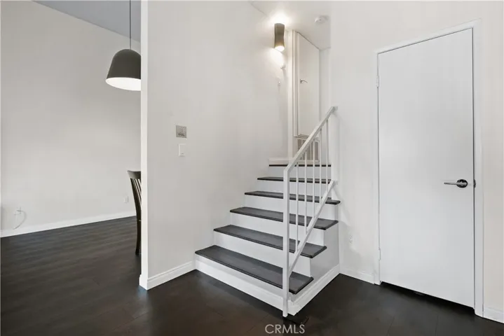 Stairs leading to private bedroom and bathroom.