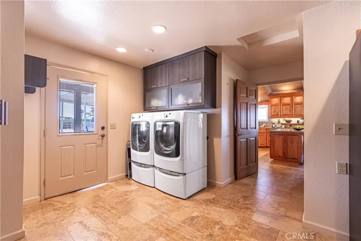 A large utiity room leads outside to the barn or into the kitchen
