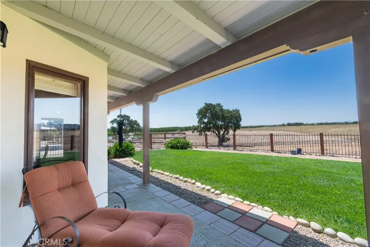 This back covered patio keeps the house cooler in Summer and is a wonderful place to enjoy the outdoors
