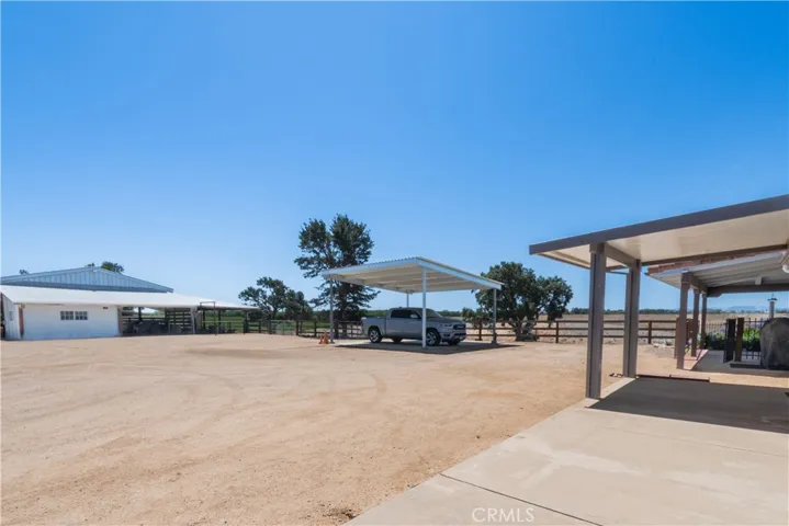 The horse corrals are adjacent to the pole barn on the right