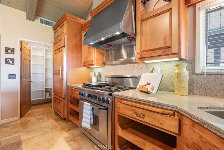 The cookstove is the focal point of the kitchen with a pantry closet nearby