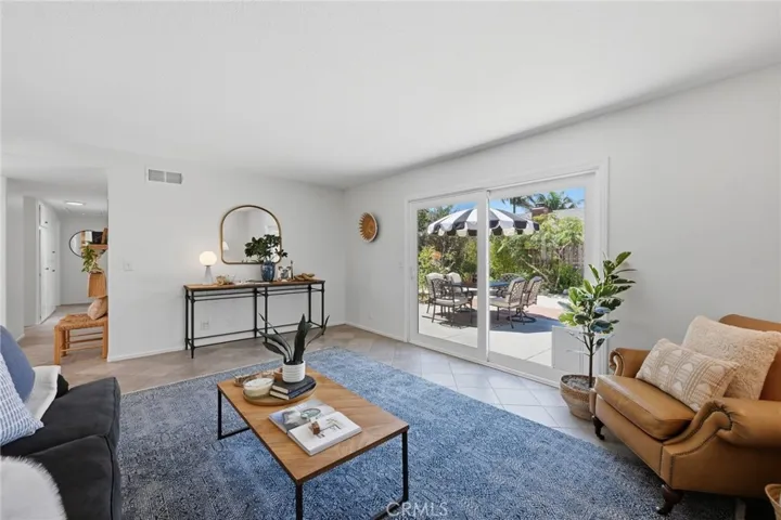 Large sliding doors facing lushly planted garden and patio