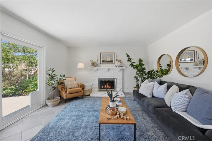 Sun-filled and stylish living room with beautiful fireplace