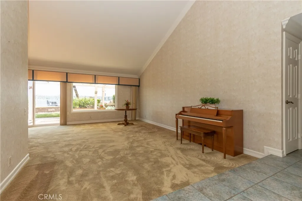 Large living room has a vaulted ceiling and fantastic windows.