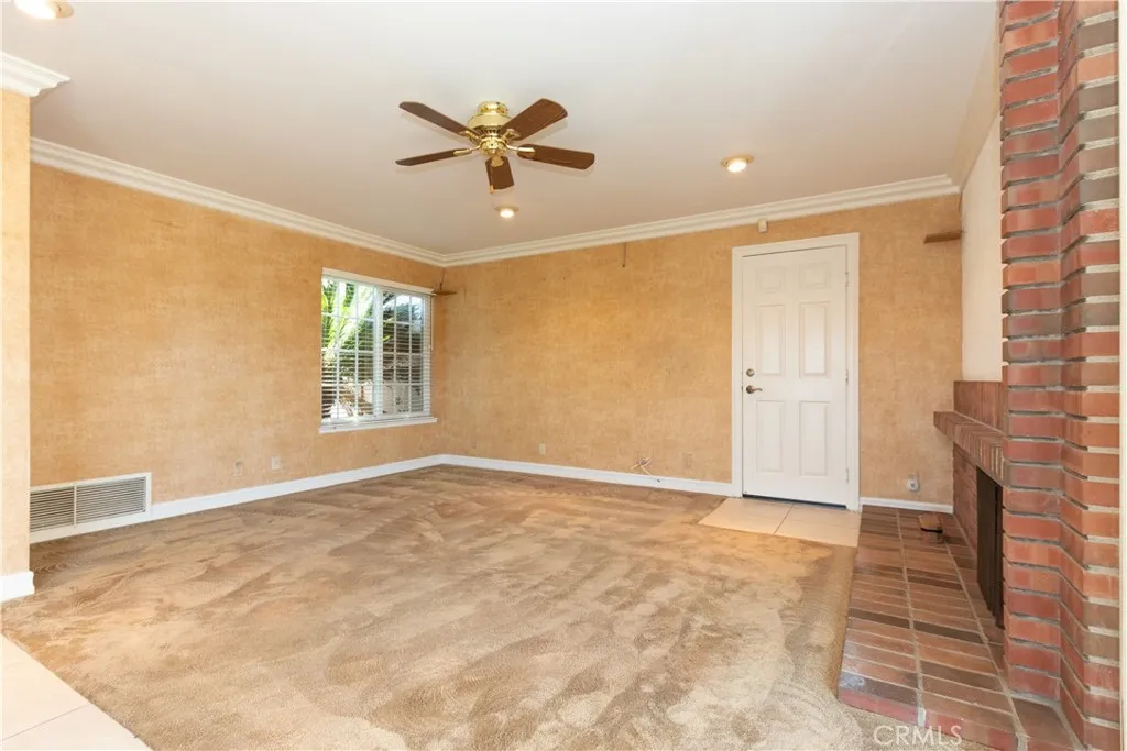Ceiling fan and garage access in the family room.