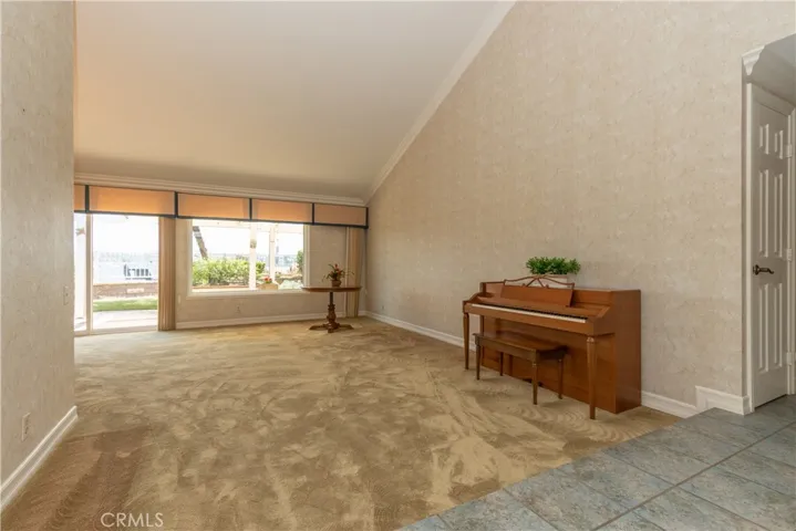 Large living room has a vaulted ceiling and fantastic windows.