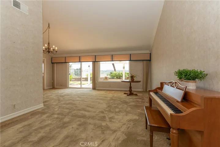 Spacious living room upon entry.