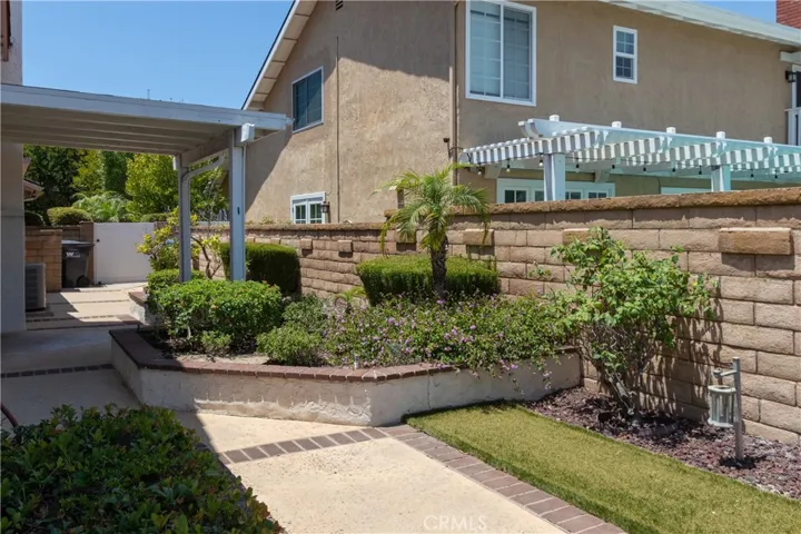 Side yard has a covered patio and raised planters.