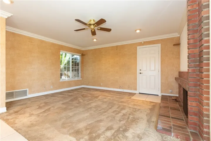 Ceiling fan and garage access in the family room.