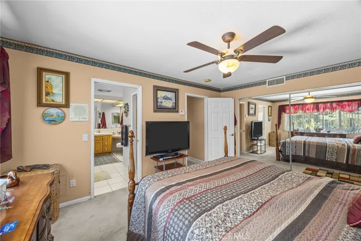 Primary suite with mirrored wardrobe