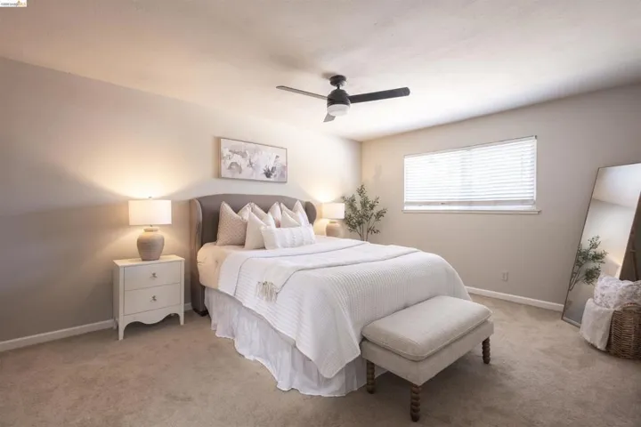 Bedroom featuring neutral wall tones, recessed lighting, and a ceiling fan