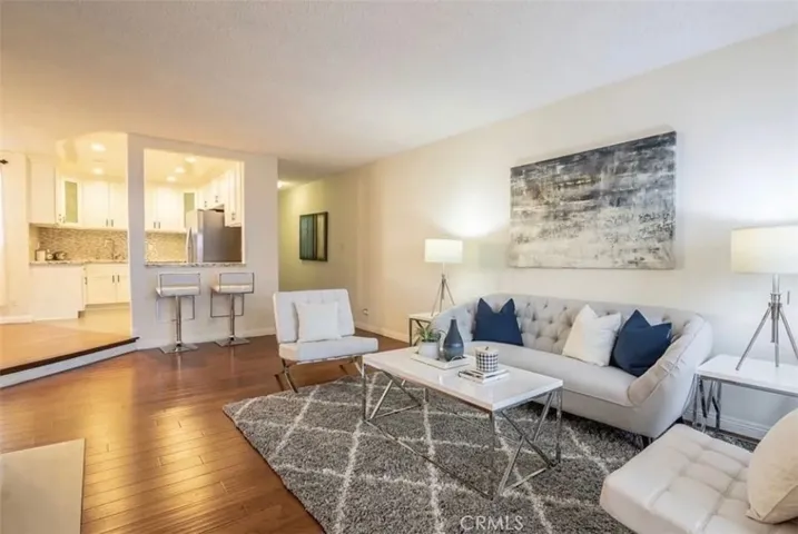Open floorplan with elegant hardwood floors in the living area