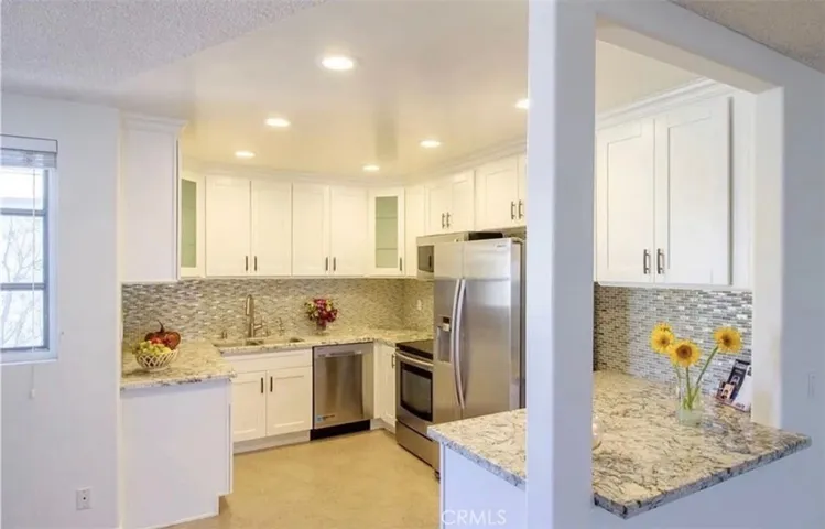 Modern kitchen featuring granite countertops and custom cabinetry.