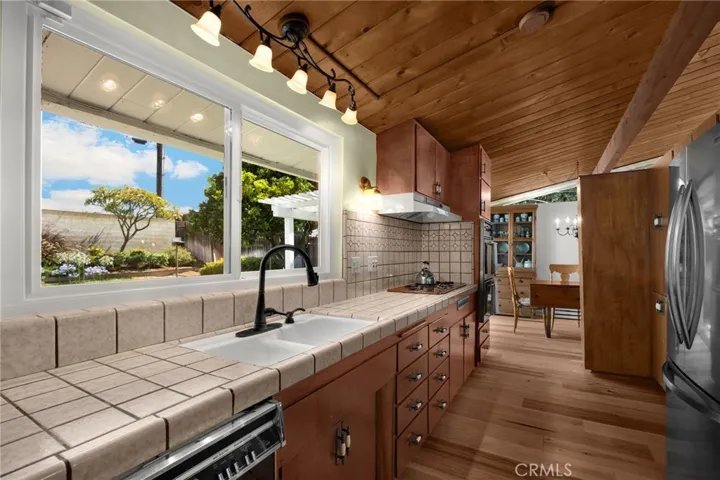 Galley kitchen . Stainless steel  fridge stays