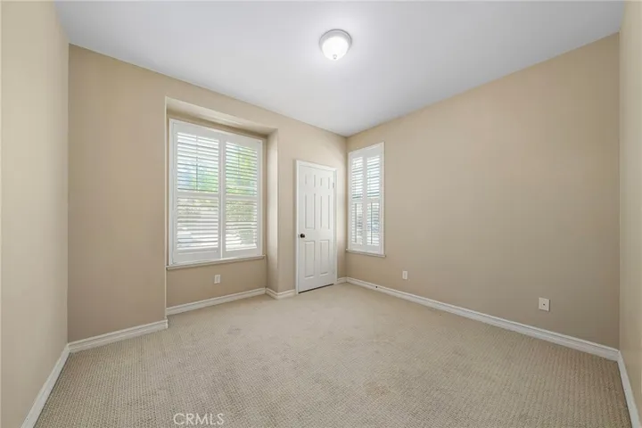 downstairs bedroom with wood shutter