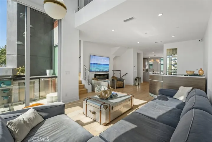 Great Room with Balcony, wine wall and opens to kitchen
