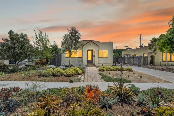 Exterior front-view of Spanish-style Bungalow with drought-tolerant landscaping