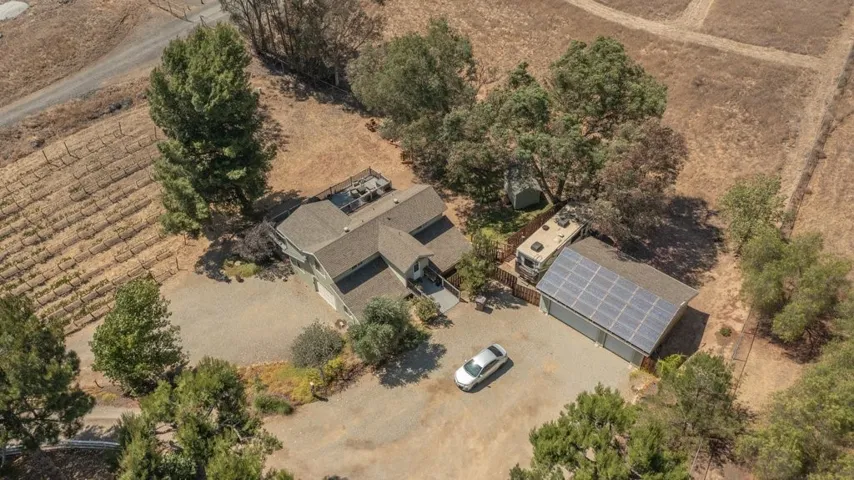 Barn with 2 rental units and 2 car garage, separate 3 car garage with 30 panels of paid off solar