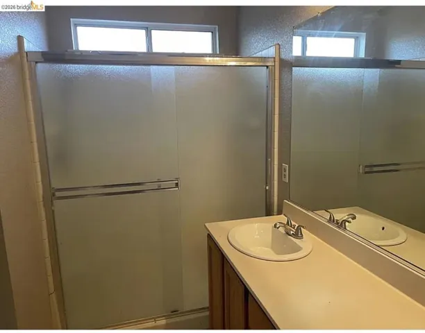 Frosted glass shower enclosure with chrome hardware