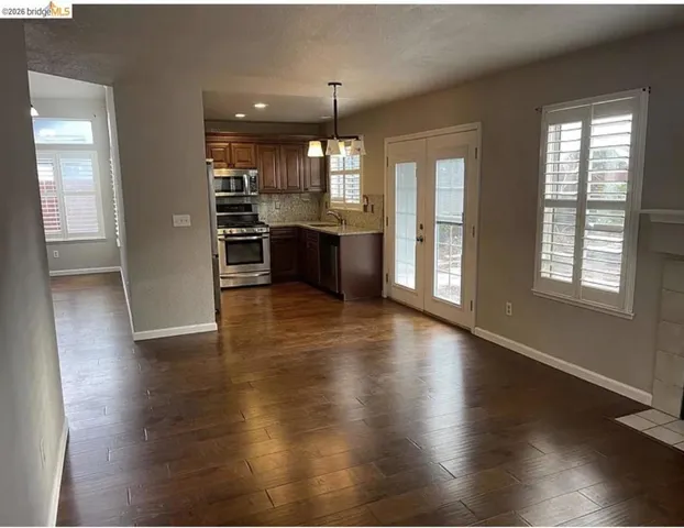 Open-concept living area featuring wood-finish flooring