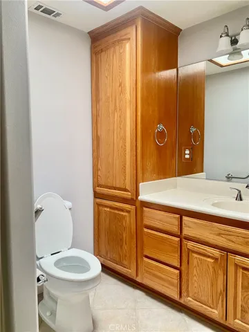HIGH BOY TOILET/OAK CABINETS WITH EXTRA STORAGE