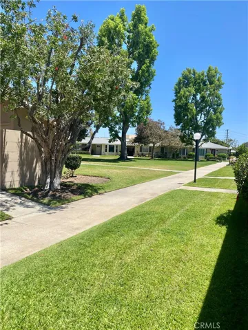 LOOKING TOWARDS THE LARGE GREEN AND CARPORTS