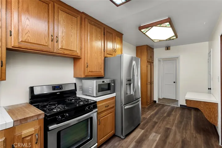 Kitchen with stainless gas stove, microwave and French-door refrigerator.