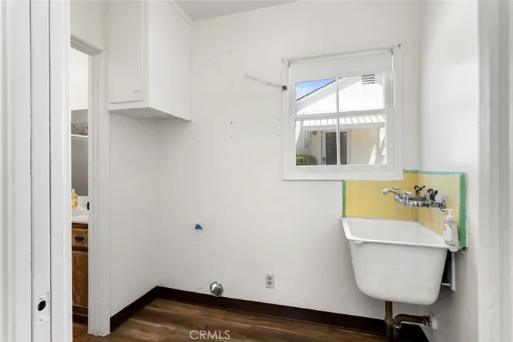 Laundry room with gas hookup and utility sink.