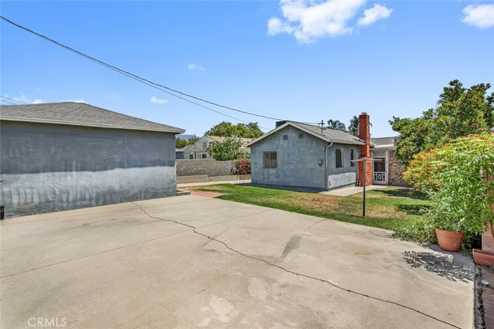 Backyard with concrete for additional parking.