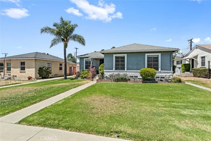 697 N 8th Avenue with walkway and lawn with sprinkler system.