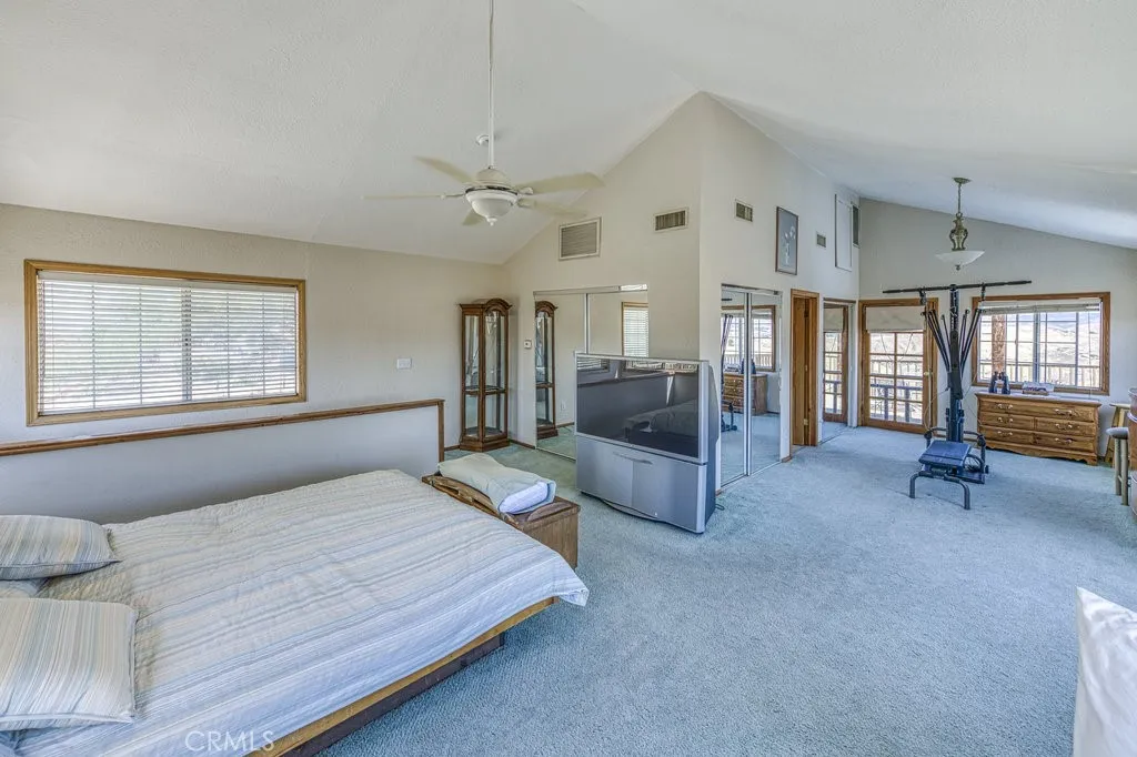 UPSTAIRS MASTER SUITE WITH VIEW TO DECK. ENJOY THE SUNSETS FROM THE DECK AWSOME VIEWS
