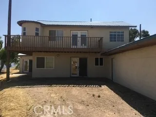 entry door next to garage view to balcony off master suite
