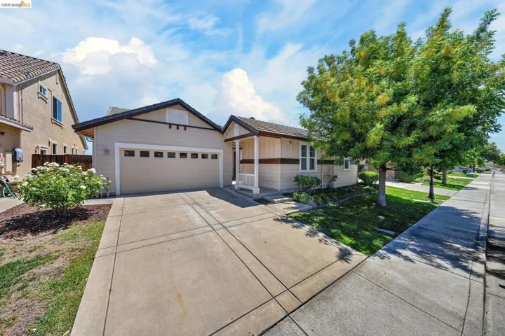 Neutral-toned exterior with a two-car garage and a paved driveway