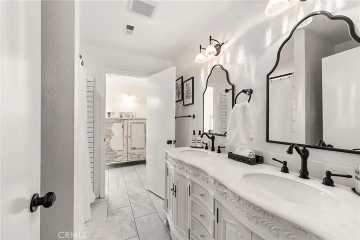 Downstairs primary bathroom with stunning vanity and double sink