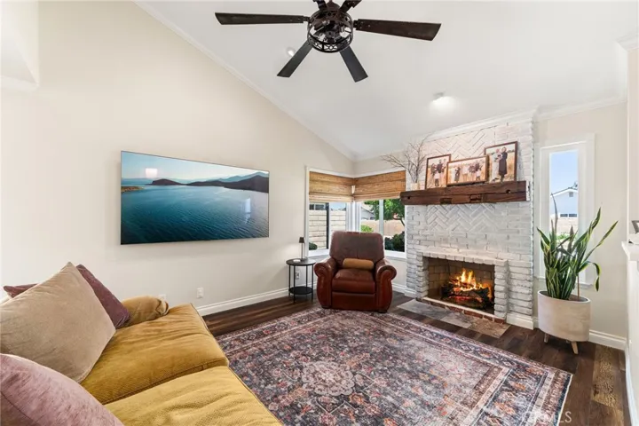 Formal living room with stunning fireplace and ceiling fan- this room connect to what could be the dining room!
