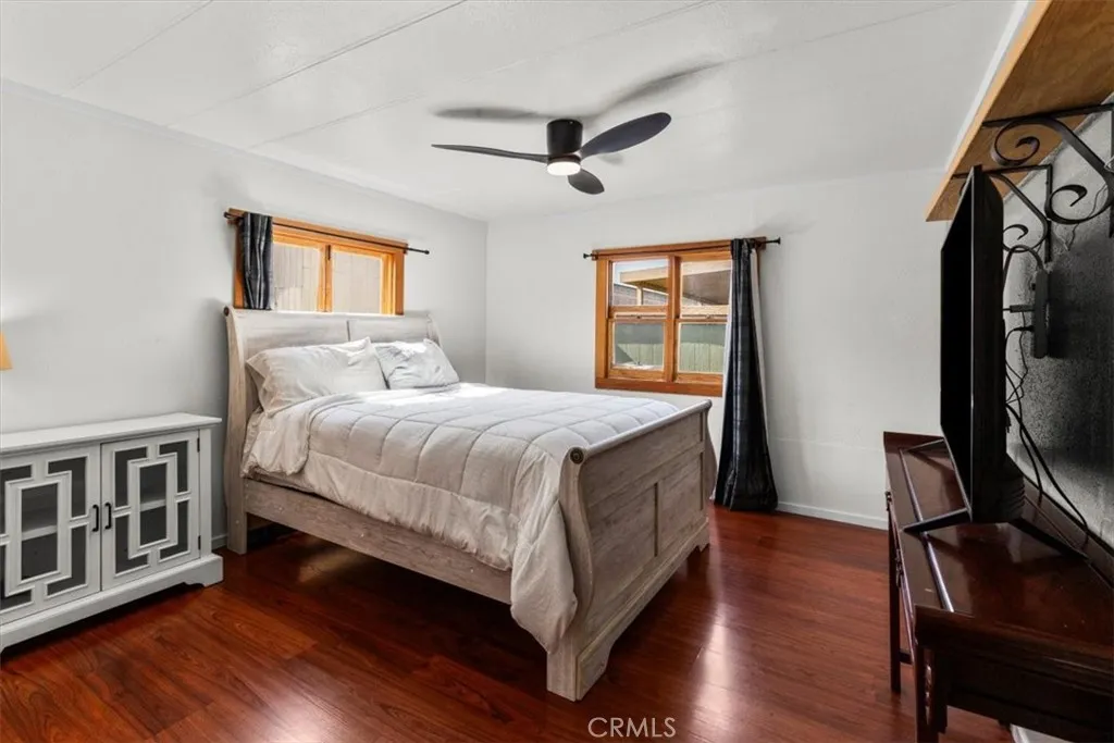 Primary bedroom with wood flooring