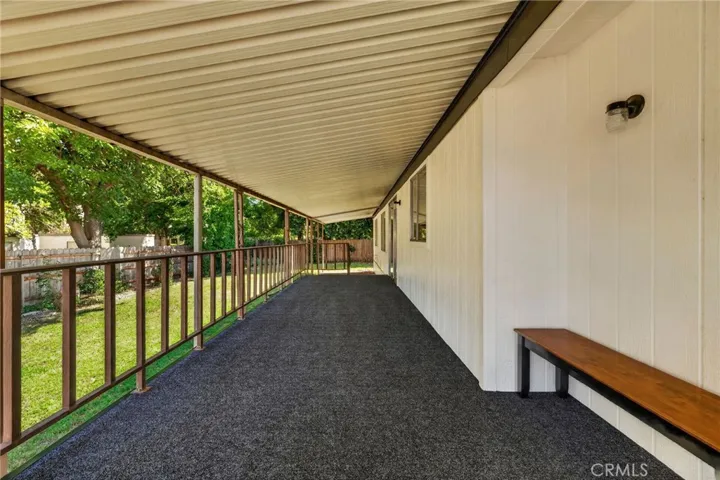 Large covered porch with newly installed carpet covering