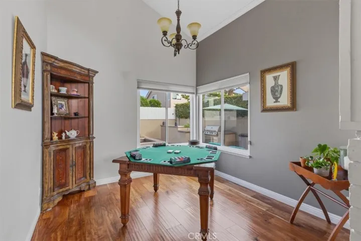 Versatile bonus room with vaulted ceilings, rich hardwood flooring, and large windows overlooking the backyard. Ideal as a game room, home office, sitting area, or flex space.